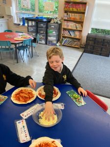 Children enjoying pizza and snacks in the Inchmarlo community room.