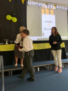 Children receiving awards at Inchmarlo school event in a bright, welcoming hall.