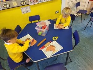Children engaging in creative activities at Inchmarlo preschool in a vibrant learning environment.