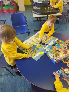 Children engaging with educational puzzles at Inchmarlo preschool.