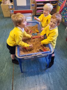 Children playing with sand at Inchmarlo preschool.