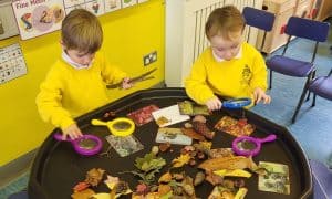 Two children playing with sensory toys in a classroom.