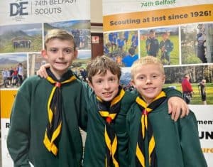 Young scouts in uniform smiling at Inchmarlo Scout Group event.