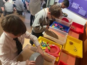 Children exploring interactive STEM toys at Inchmarlo outdoor learning center.