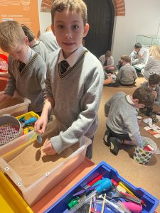 Young students engaged in learning activities at Inchmarlo School, fostering creativity and education.