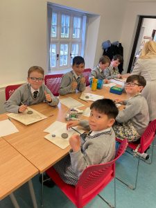Children studying together in classroom at Inchmarlo School in Scotland.