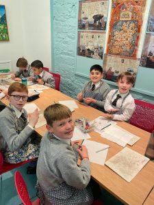 Children studying and writing in classroom environment.