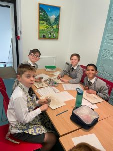 Children studying together at Inchmarlo School in a bright classroom environment.