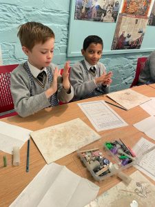 Two young students engaging in classroom activities at Inchmarlo.