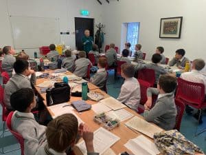 Engaged students in a classroom at Inchmarlo, focused on learning and education.