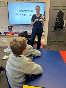 Interactive classroom teaching with a teacher and students engaged.