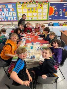 Children working on arts and crafts in a classroom setting.