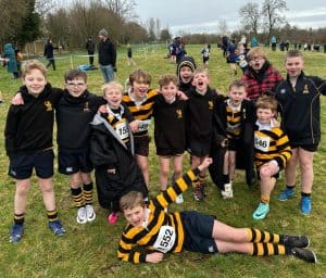 Group of cheerful students in sports uniforms at Inchmarlo school sports day.