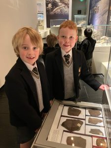 Two children exploring museum exhibits at Inchmarlo, engaging with educational displays and artifacts.