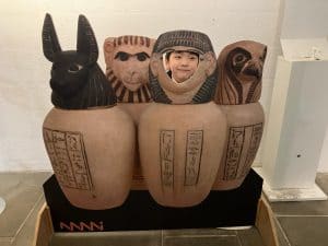 Colorful carved wooden figures at Inchmarlo estate in Scotland.