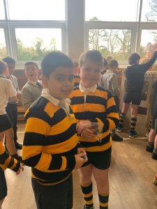 Two children in school uniforms at Inchmarlo School, engaging in activities inside a bright classroom.