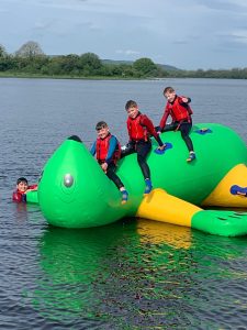 Children enjoying water activity at Inchmarlo with inflatable aquatic play area.