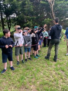 Children's outdoor activity at Inchmarlo estate with guide and group in nature.
