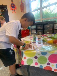 Young boy engaging in arts and crafts at Inchmarlo Montessori School.