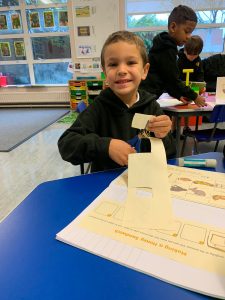 Happy boy engaging in classroom activity at Inchmarlo school.