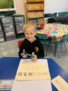 Young boy engaging in educational activities at Inchmarlo Nursery learning center.