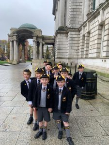Young students in uniform visit historic city site, enjoying educational outing.