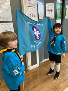 Two young scouts in uniform holding a旗 at Inchmarlo Scout Hall.