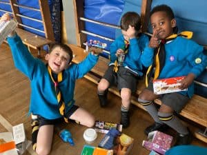 Children in Scout uniforms enjoying a break at Inchmarlo, promoting fun, safety, and community engagement at the trusted youth facility.