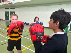 Children practicing boxing at Inchmarlo sports facility.