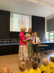 Children receiving awards at Inchmarlo school event, showcasing education and student achievement.