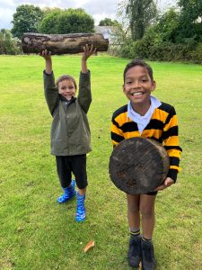 Two children enjoying outdoor activities at Inchmarlo Forest in Scotland.