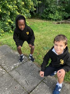 Two children in school uniforms outdoors at Inchmarlo school playground.