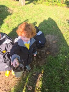 Child exploring nature at Inchmarlo Gardens, outdoor learning and play for kids.
