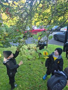 Children playing outdoors at Inchmarlo estate with lush greenery and tree canopy.
