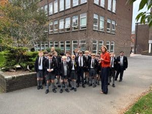 Group of students with teacher outside Inchmarlo school in Scotland.