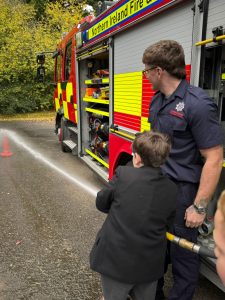 Firefighters and trainee preparing fire engine at Inchmarlo estate.