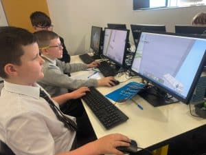 Students engaging with computer technology at Inchmarlo.