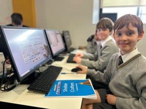 Students using computers in a classroom setting at Inchmarlo School.