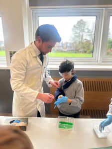 Care home residents engaging in a science activity outdoors.