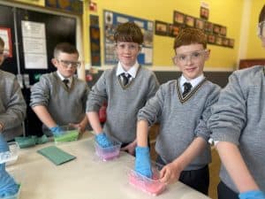 Students engaging in science experiments at Inchmarlo School, highlighting excellence in education and student activity.