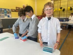 Children engaging in science activity during school day.