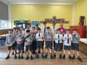Happy children holding awards in school assembly at Inchmarlo.