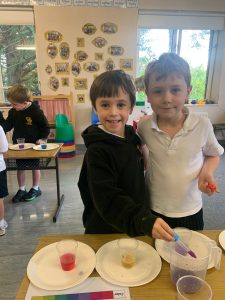 Two children smiling with baked goods at Inchmarlo preschool.