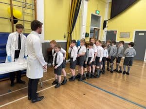 Students lining up at Inchmarlo School in a spacious, well-lit classroom environment.