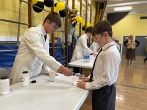 Students conducting a science experiment at Inchmarlo, highlighting educational programs and engaging activities.