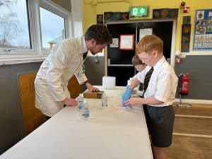 Students conducting science experiments at Inchmarlo school, engaging in hands-on learning.