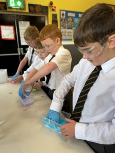 Students conducting science experiments in a classroom at Inchmarlo School.