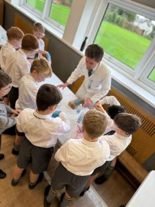 Students engaging in a hands-on science activity at Inchmarlo School classroom.