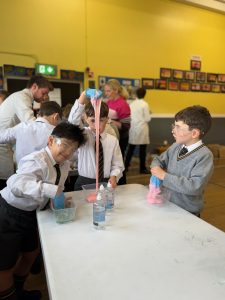 Children engaging in a science experiment at Inchmarlo education center.