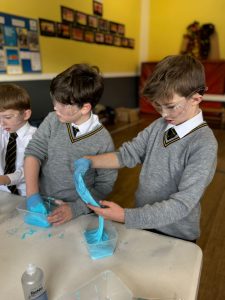 Young boys engaging in science activity at Inchmarlo school.